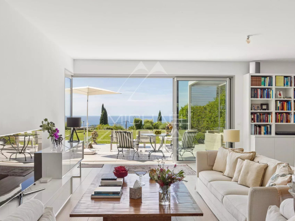 Interior of a bright apartment with garden and sea views in Nice, modern and spacious furniture.