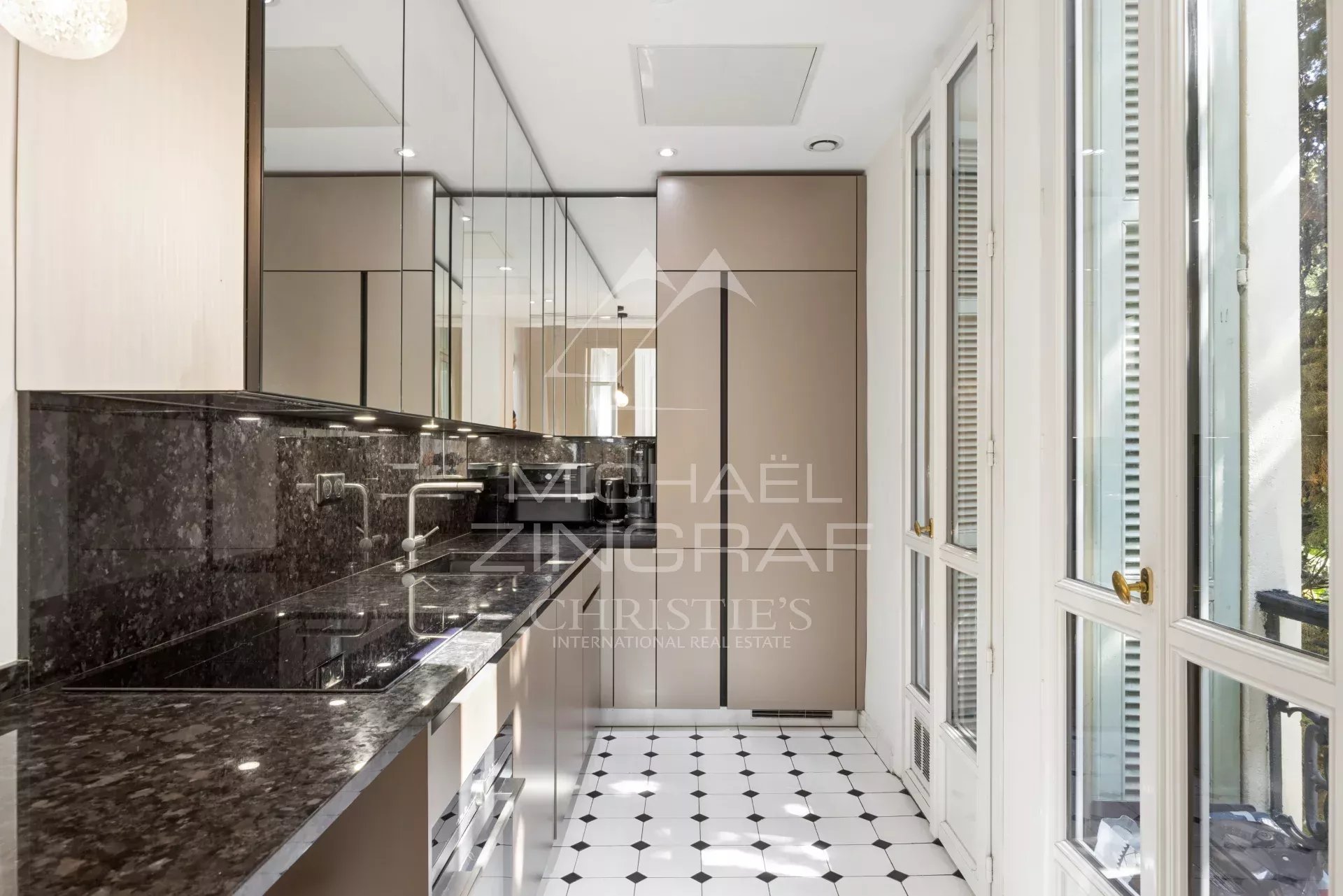 Kitchen of an apartment in Nice Modern kitchen with marble countertop and black and white tiles in an apartment in Nice.