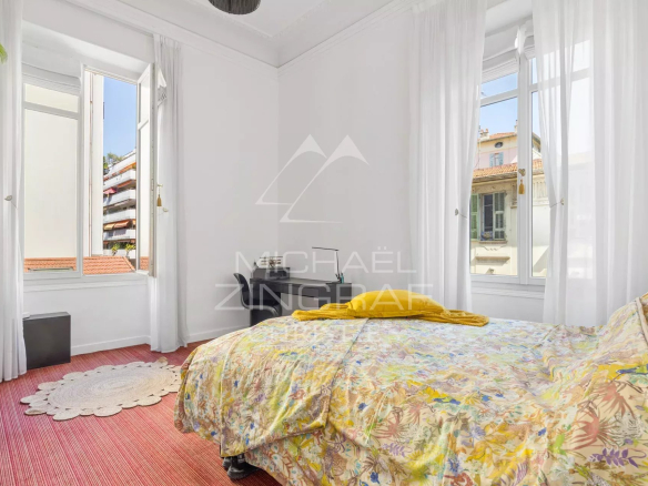 Room in a Nice apartment with bright windows and colorful decor.