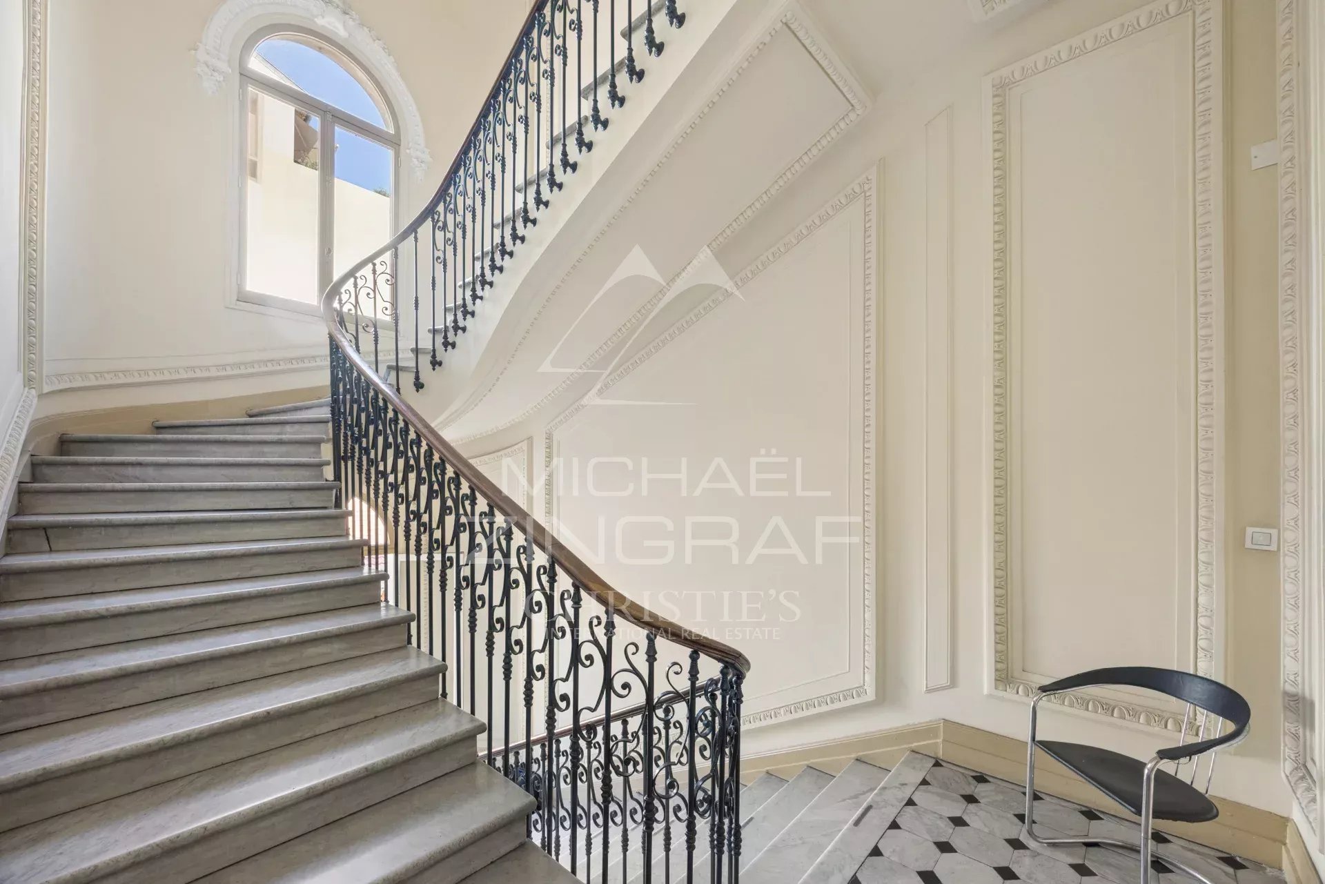 Staircase of an old building in Nice Staircase of an elegant old building with wrought iron balustrade and ornate walls.