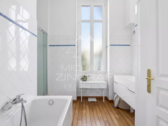 Bathroom in a Nice apartment with bathtub and bright window.