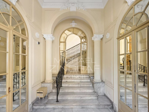 Entrance to an elegant old building with marble staircases and ornate walls in Nice.