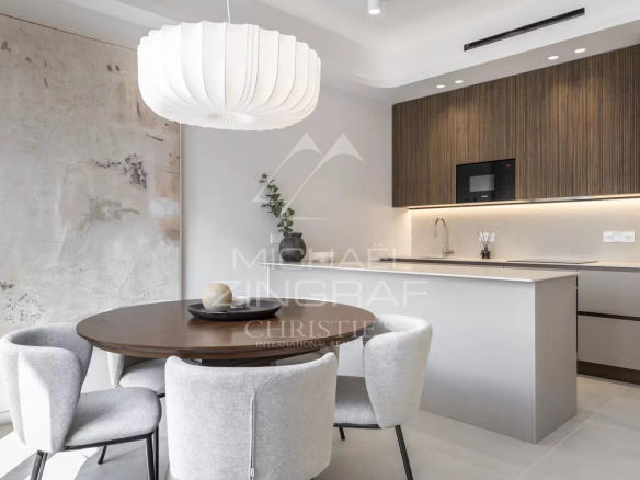 Interior of a renovated apartment with a modern kitchen and elegant dining room.