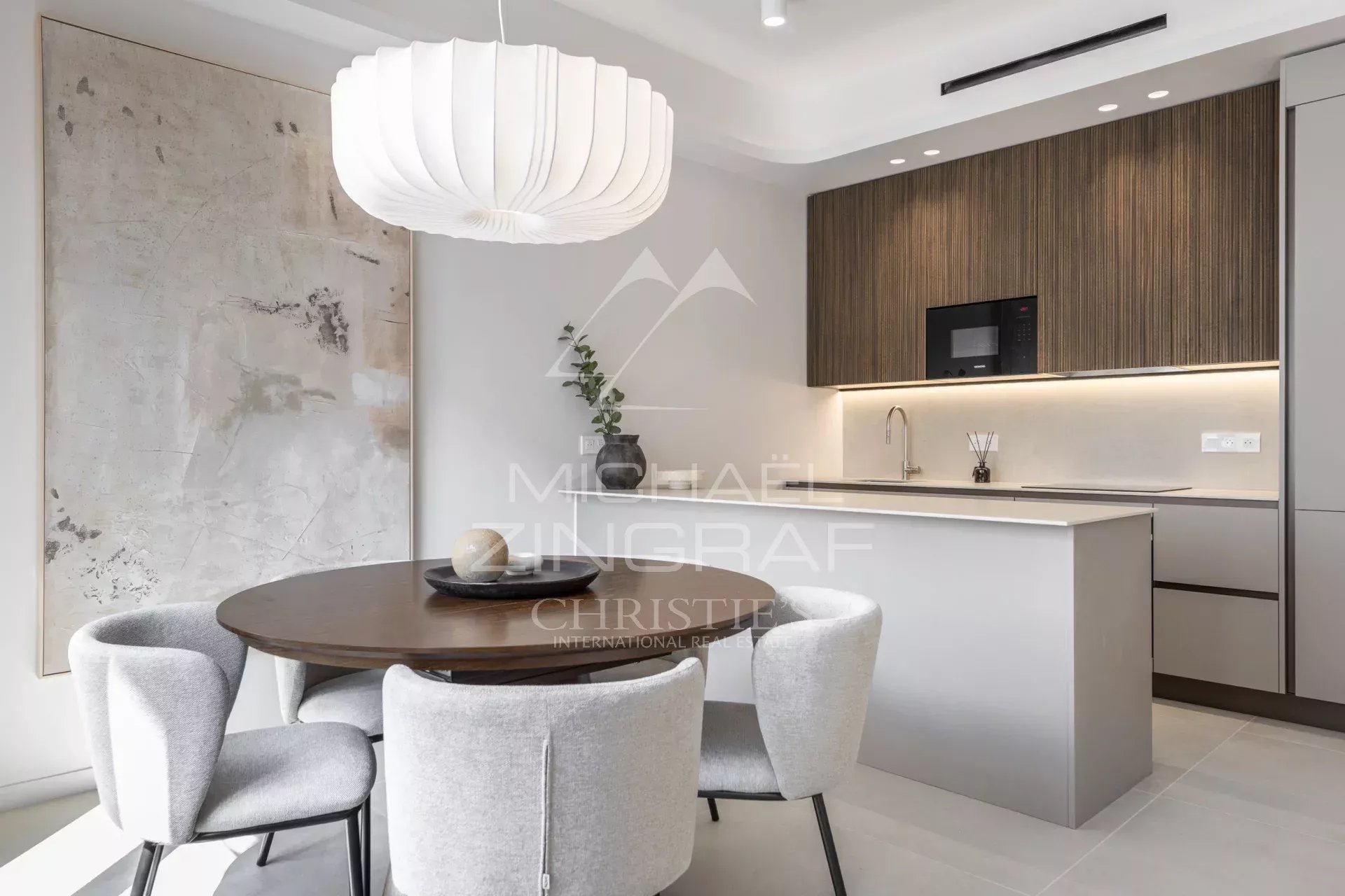 Interior of a renovated apartment with a modern kitchen and elegant dining room.