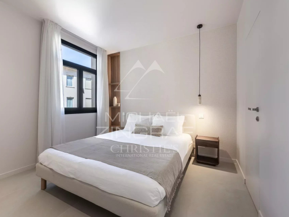 Room in a renovated apartment with a double bed and modern decor.