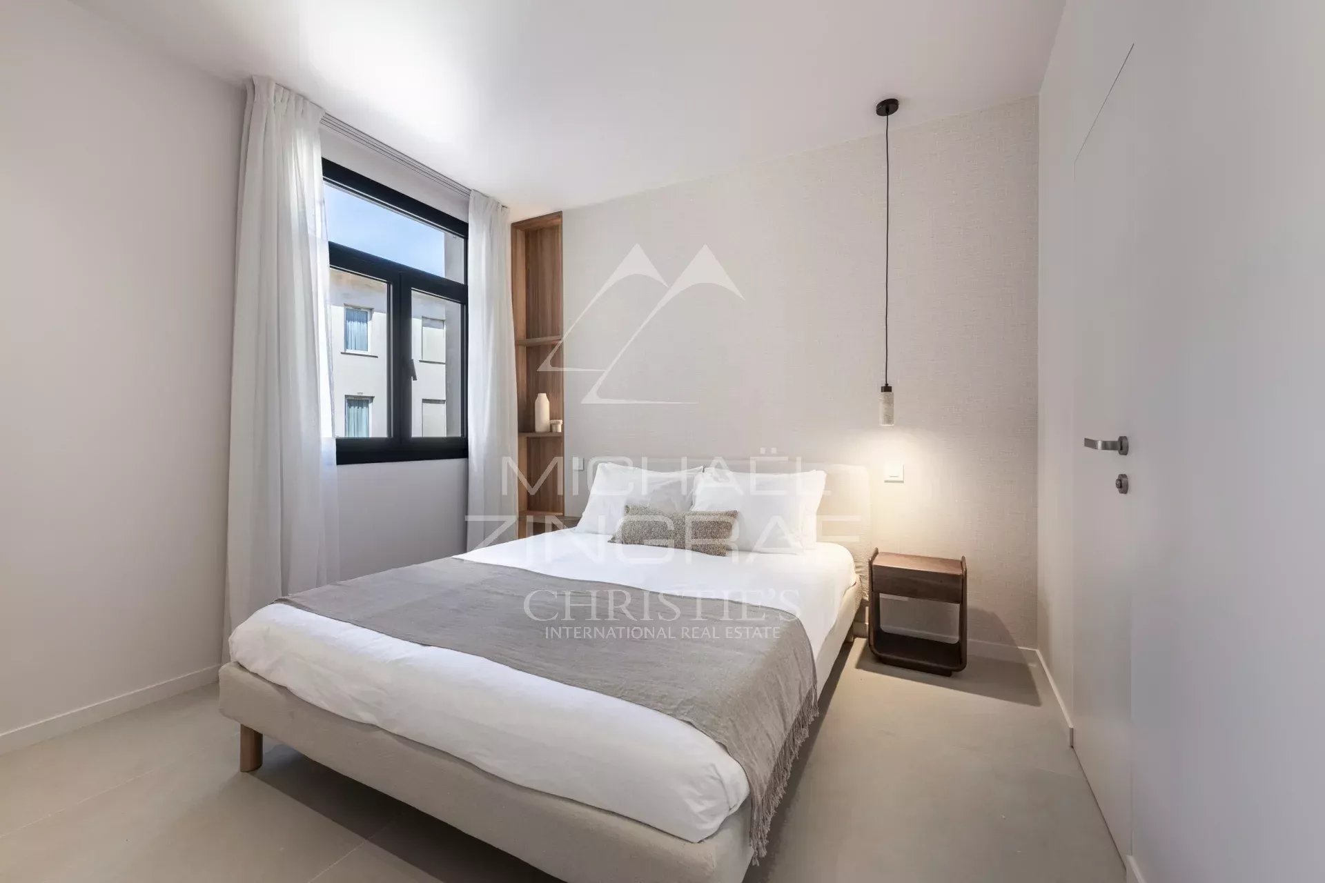Room in a renovated apartment with a double bed and modern decor.