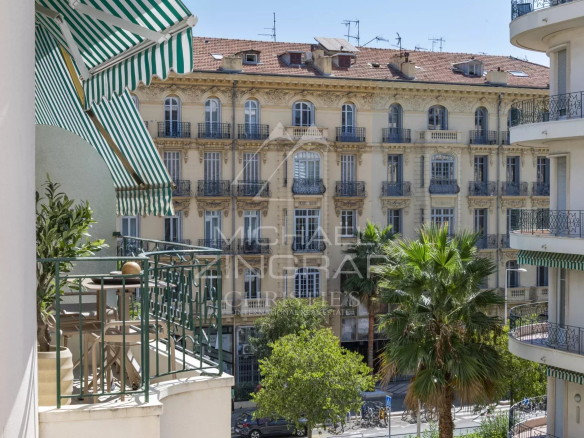 View from a balcony of an apartment on Boulevard Victor Hugo in Nice, with historic buildings in the background.