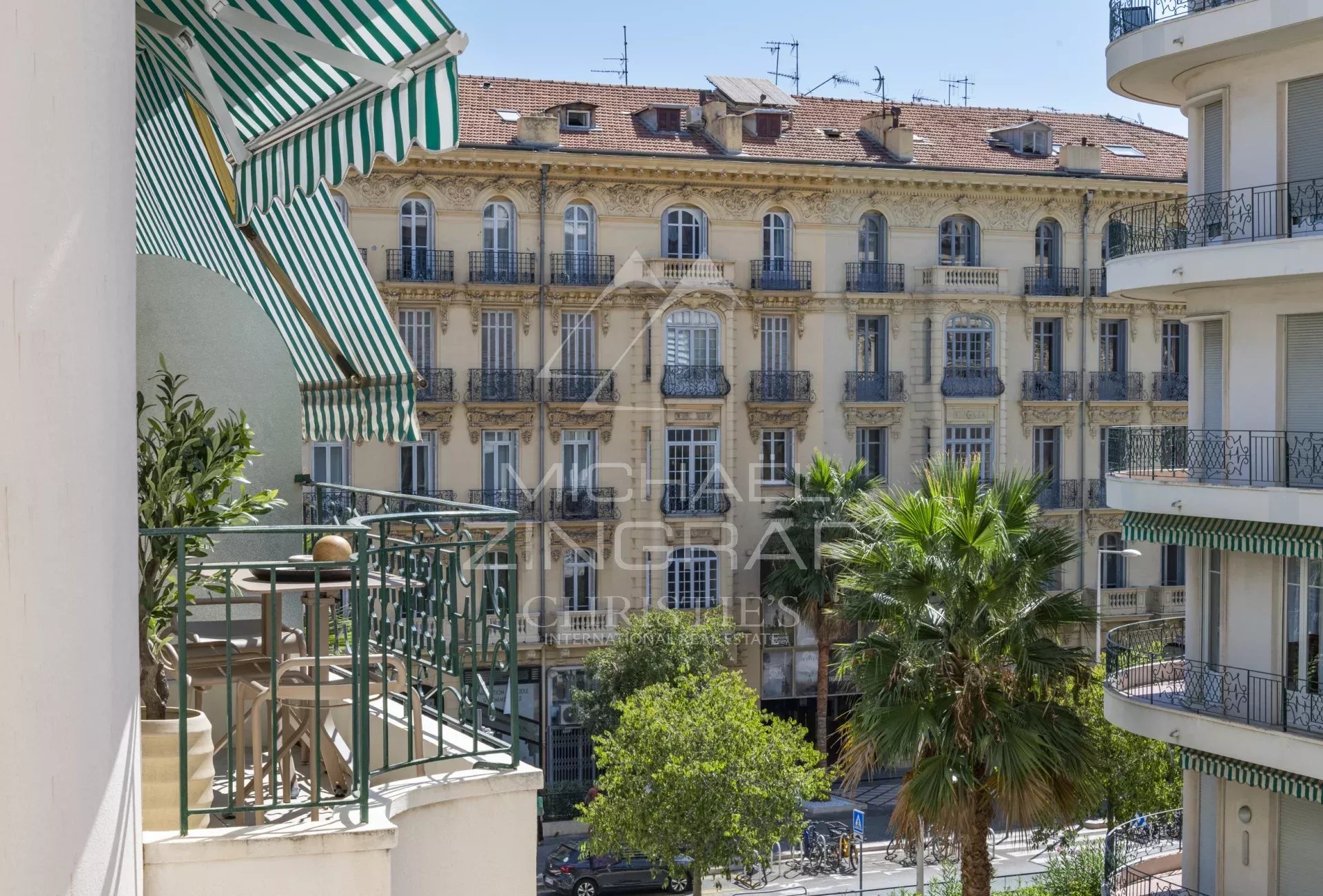 View from a balcony of an apartment on Boulevard Victor Hugo in Nice, with historic buildings in the background.