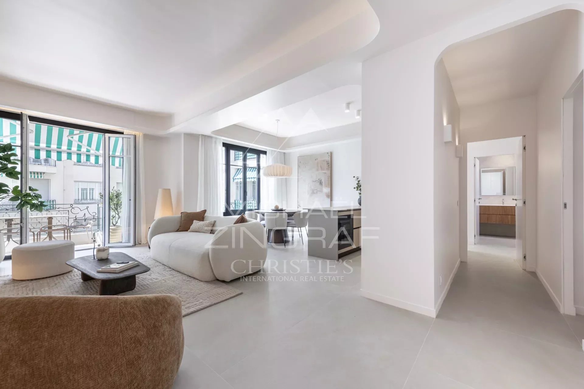 Interior of a renovated apartment with a bright living room, two bedrooms and access to a balcony.
