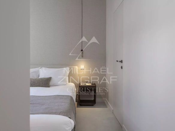 Room in a renovated apartment with a double bed and modern decor.