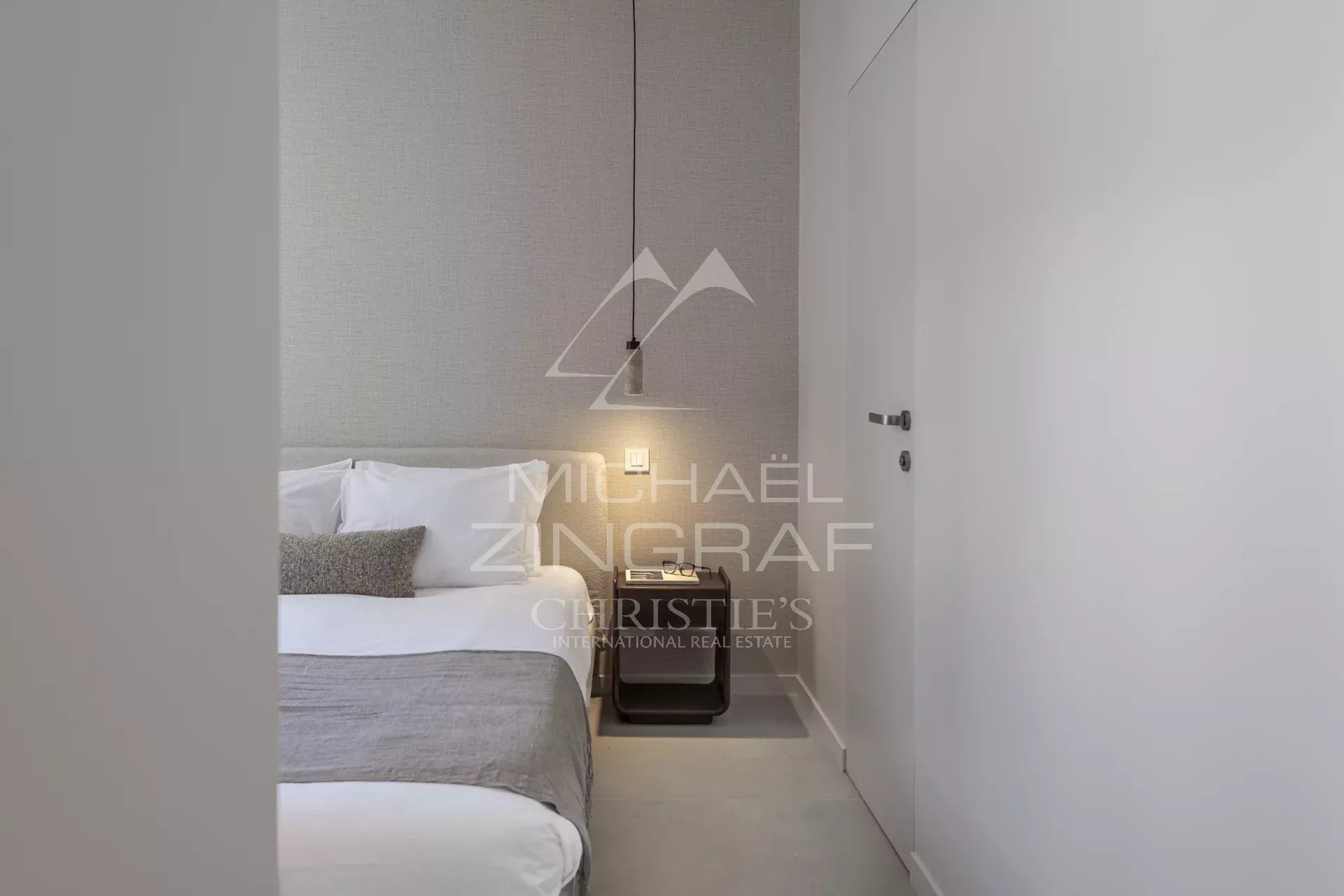 Room in a renovated apartment with a double bed and modern decor.