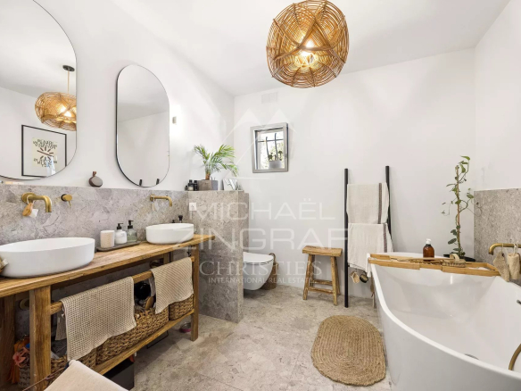 Modern bathroom with bathtub and double marble sink