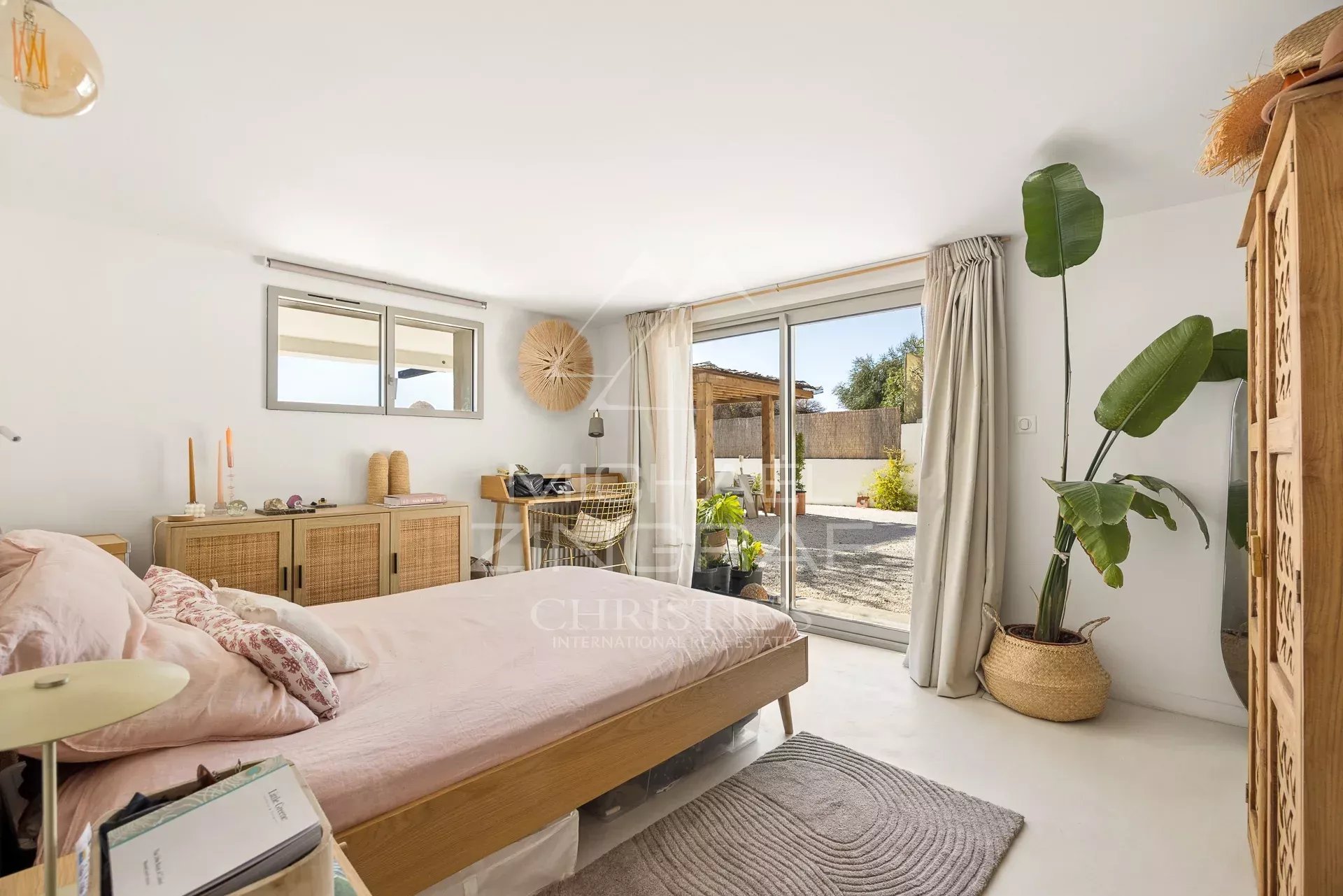Chambre lumineuse d'une villa rénovée à Nice, avec accès à l'extérieur.