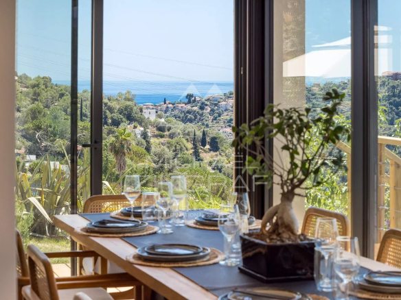 Bright dining room with views of the hills and the sea in Nice.