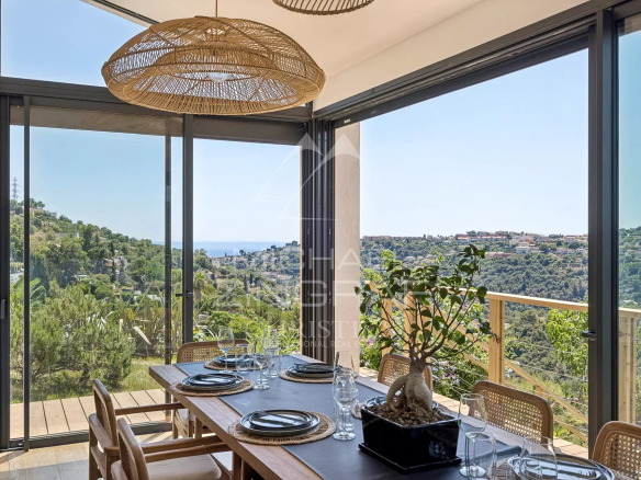 Bright dining room with views of the hills and the sea in Nice.