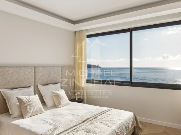 Chambre avec vue sur la mer à Nice, Cap de Nice, avec un lit et de grandes fenêtres.