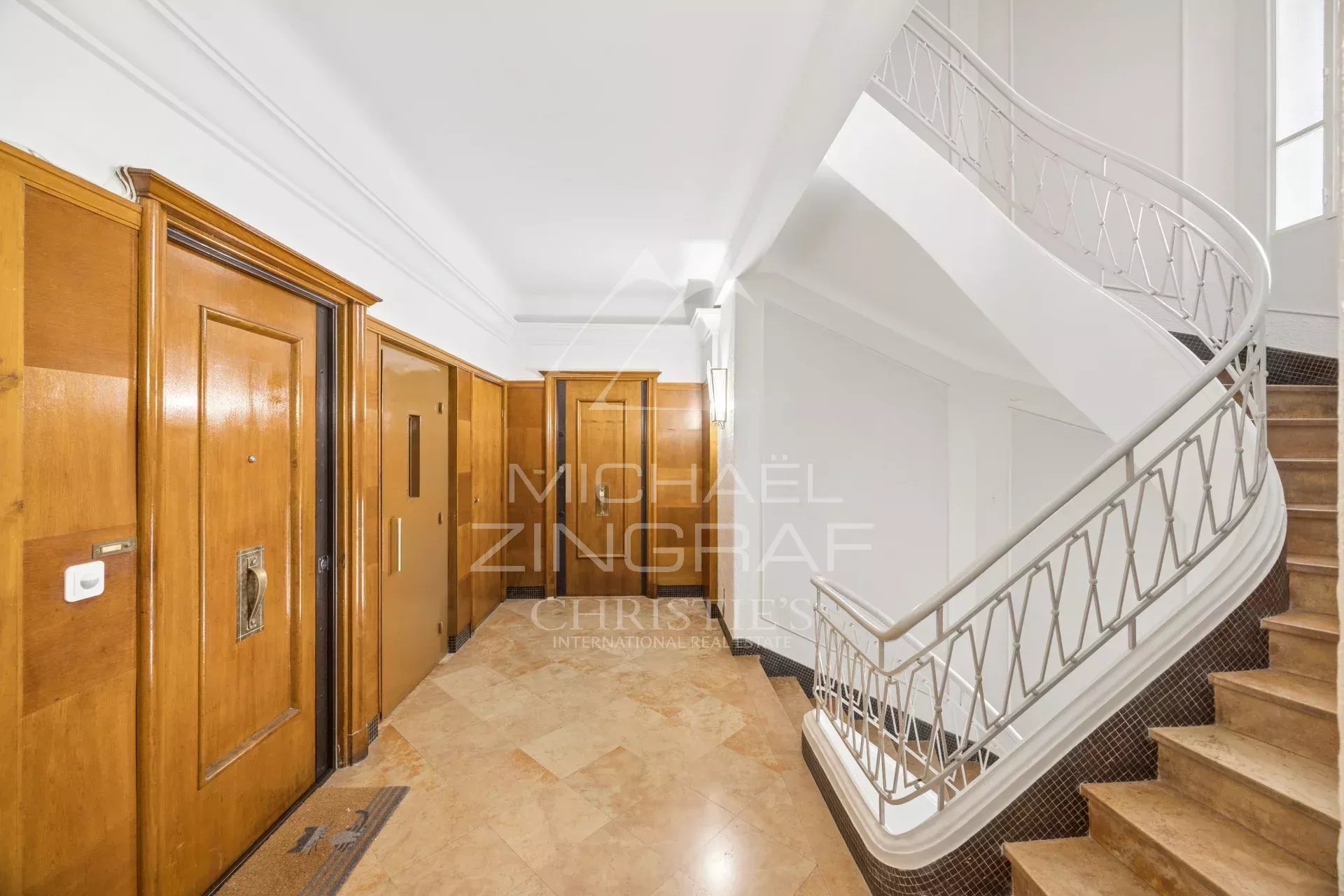 Entrance to a building in Nice Entrance to a building with wooden doors and a marble staircase