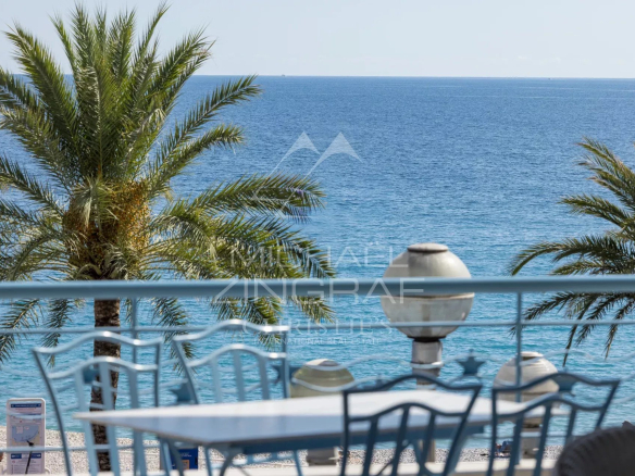 View of the Mediterranean Sea from a terrace with palm trees in Nice.