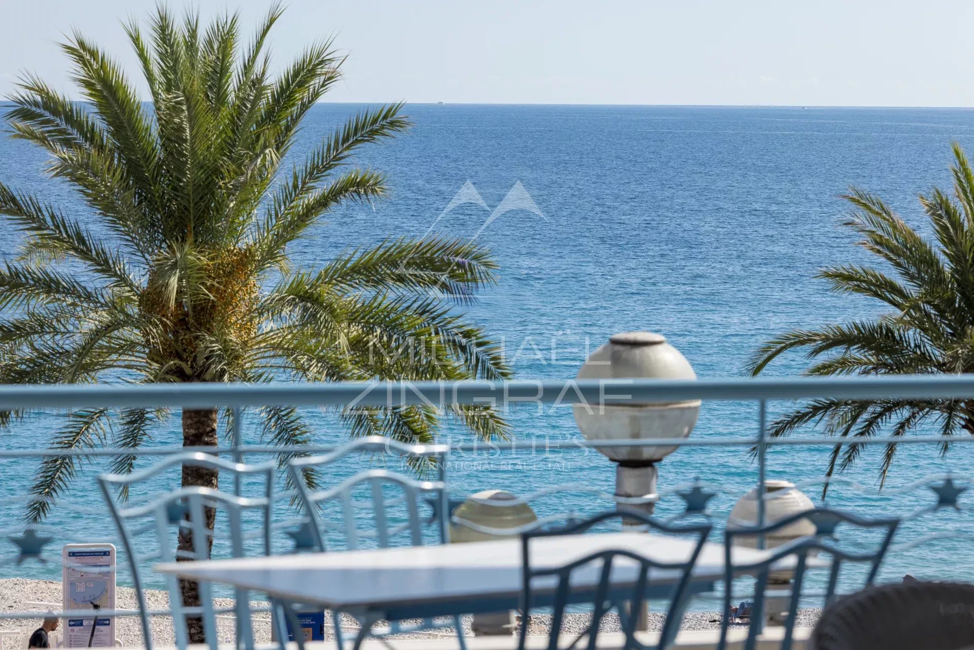 View from the terrace in Nice View of the Mediterranean Sea from a terrace with palm trees in Nice.