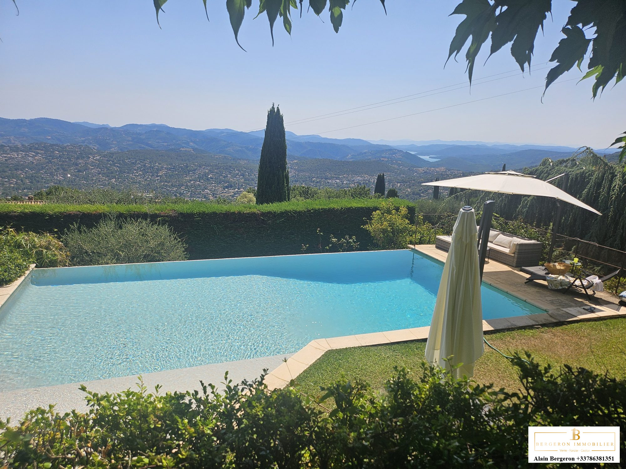 Luxury villa in Cabris View of a villa with swimming pool and mountain scenery in the background in Cabris.