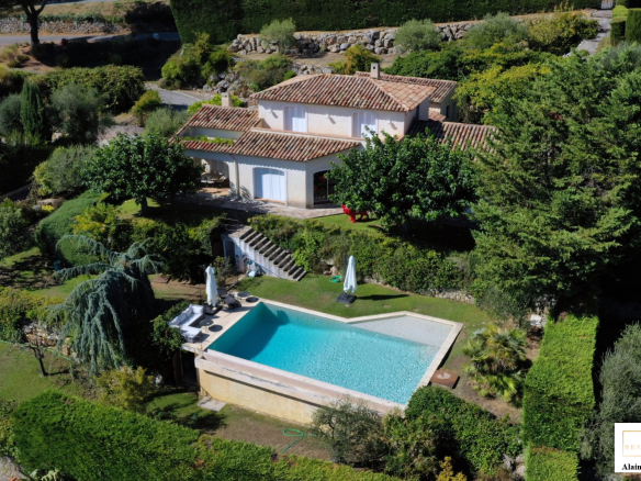 Aerial view of a villa with swimming pool and garden in Cabris, France.
