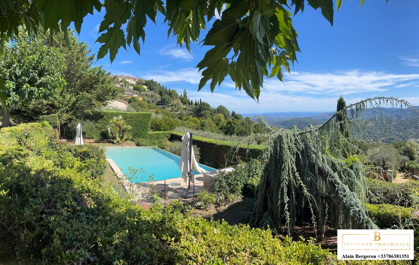 Luxury villa in Cabris View of a villa with swimming pool and garden in Cabris, surrounded by greenery and hills.