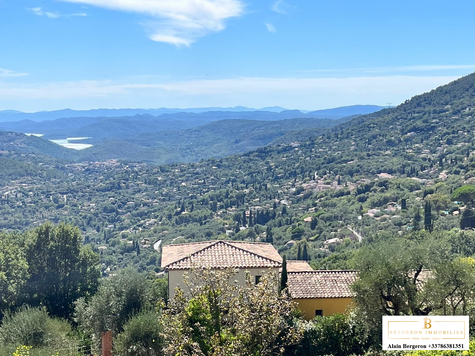 View from a villa in Cabris Panoramic view from a villa in Cabris, with green hills and a blue sky.