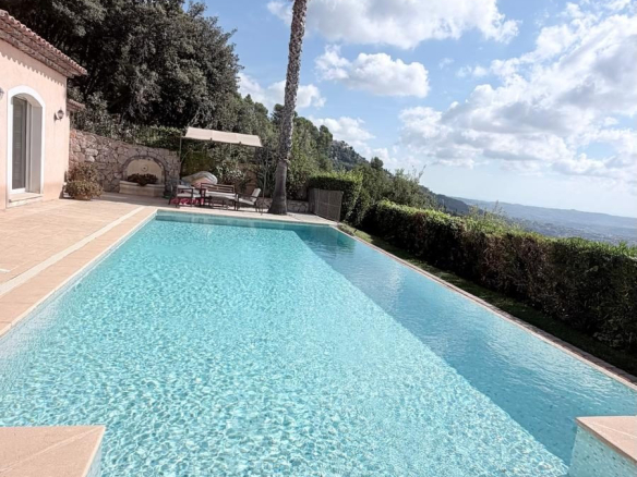 Villa avec piscine et vue panoramique à Spéracèdes, ciel nuageux en arrière-plan.