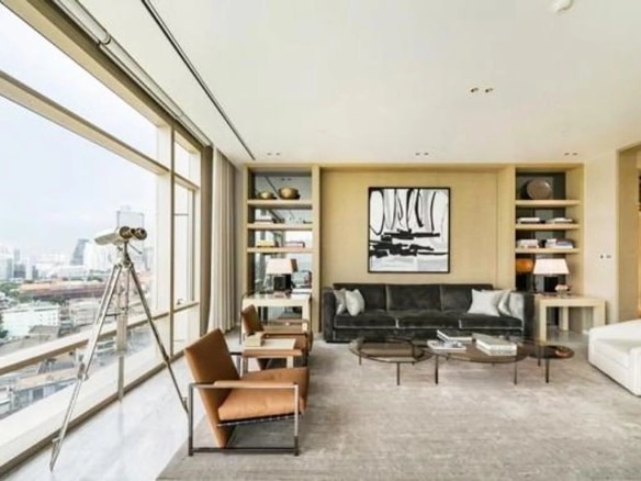 Interior of a luxury penthouse with a modern living room and city views in Bangkok.