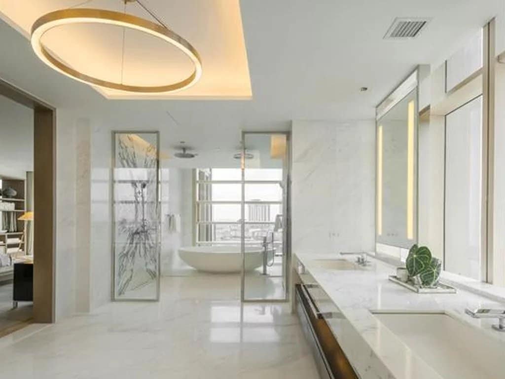 Modern and spacious bathroom in a luxury apartment in Bangkok, with bathtub and panoramic windows.