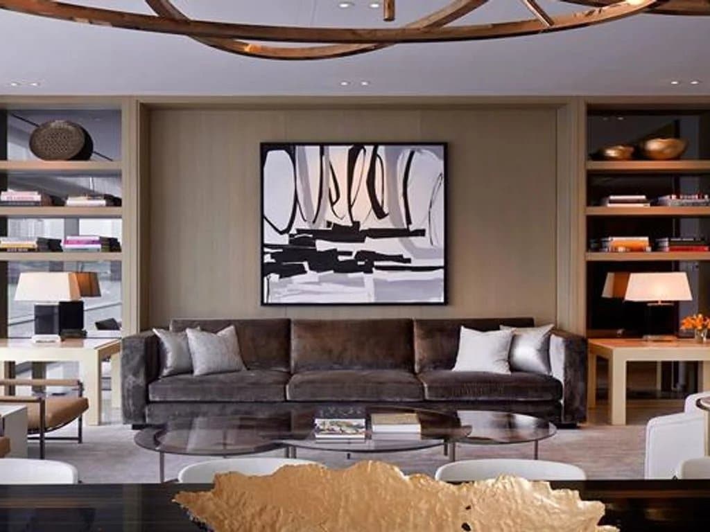 Interior of a luxury apartment in Bangkok with a modern living room and a piece of wall art.