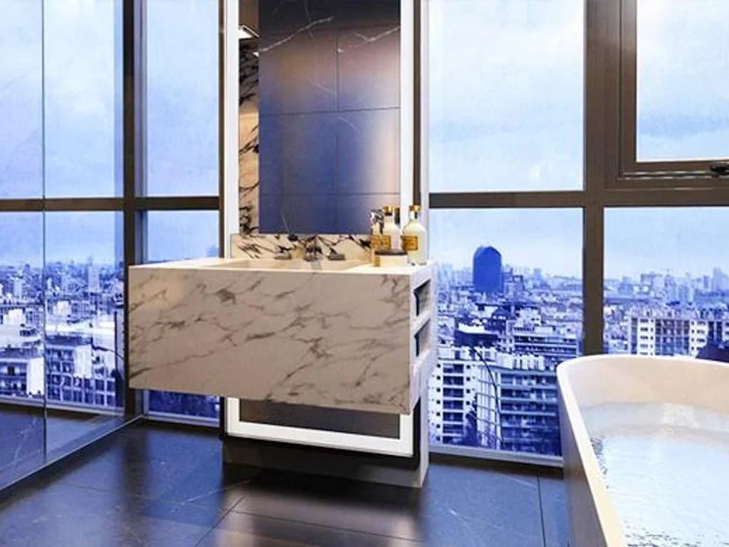 Modern bathroom with marble sink and a view of Bangkok city.