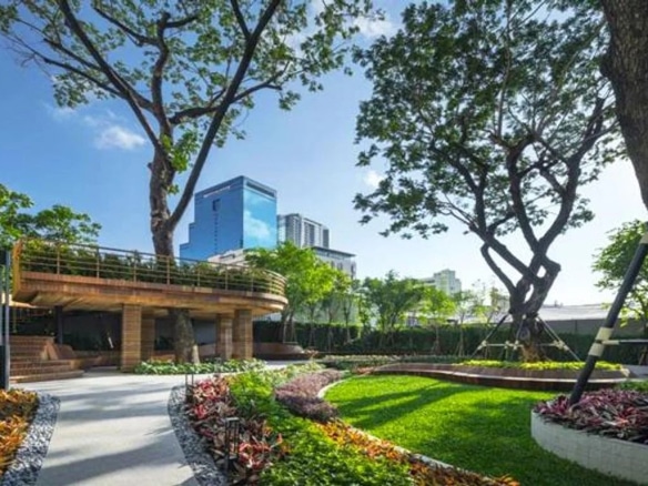 Garden of an apartment in Bangkok with well-maintained trees and plants.