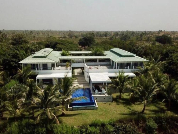 Vue aérienne d'une somptueuse propriété avec piscine et jardins, située près de la plage à Cap Skirring, Sénégal.