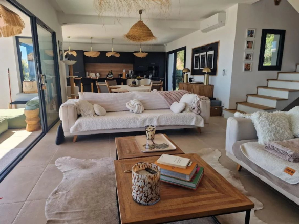 Interior of a modern villa with a bright living room, elegant furniture and a sea view.