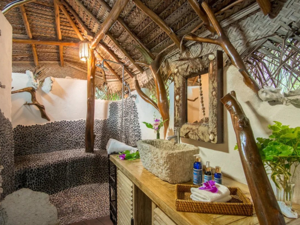 Salle de bains d'un éco-lodge de luxe avec décoration naturelle et matériaux locaux.
