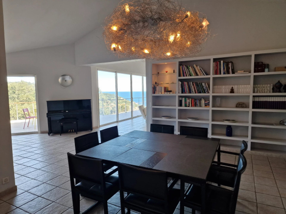 Interior of a property with sea views, bright dining room and living room.