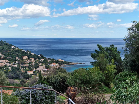 Panoramic sea view from a property in the hills above Conca, with green hills in the foreground.