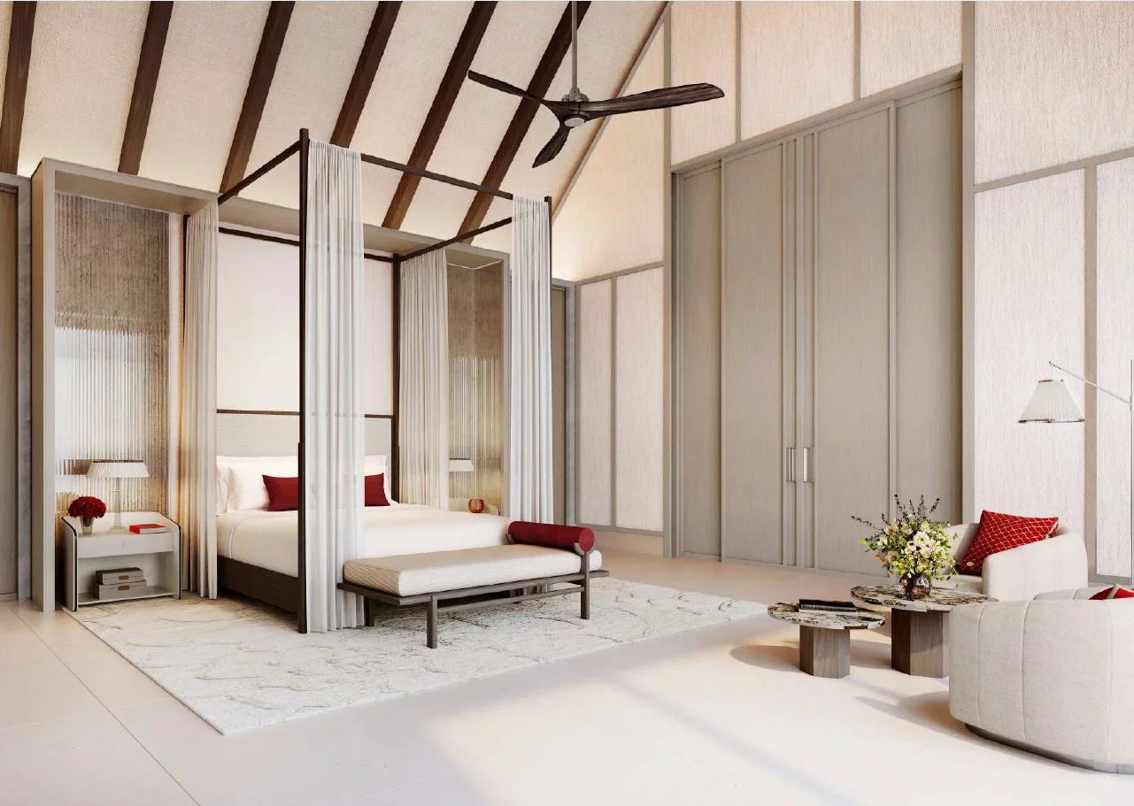 Chambre d'une villa de luxe avec lit à baldaquin et décoration élégante aux Maldives.