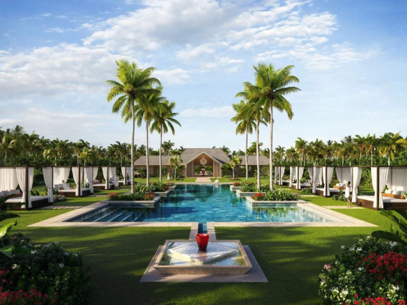 Vue d'une piscine entourée de palmiers et de cabanas dans un complexe de villas de luxe aux Maldives.