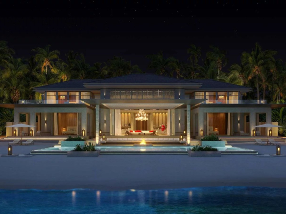 Villas de luxe au bord de la mer dans le South Malé Atoll, Maldives, illuminées la nuit.