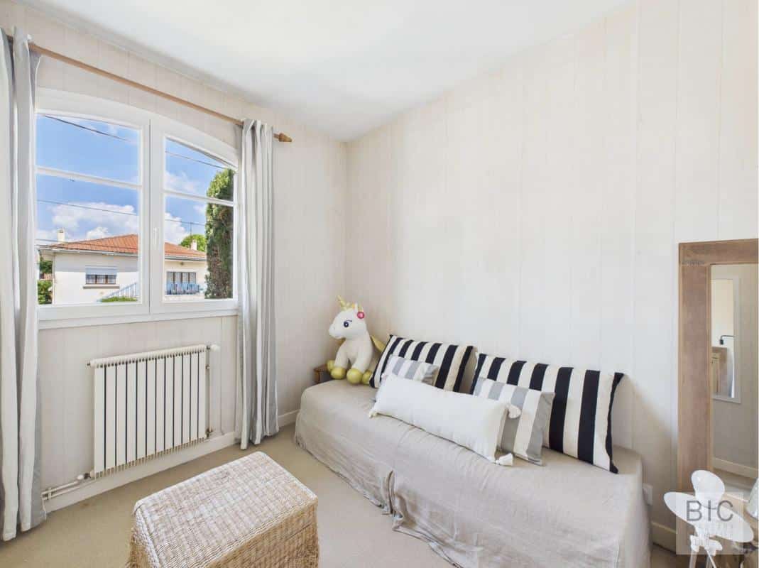 Chambre d'une maison familiale à Mérignac, avec canapé et décoration enfantine.