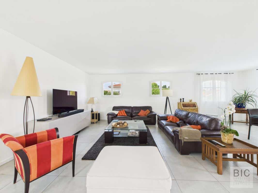 Intérieur d'une maison familiale spacieuse avec salon lumineux et mobilier moderne.