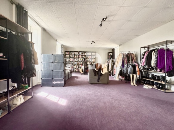 Interior of a house in Laval with clothes shelves and a spacious living area.
