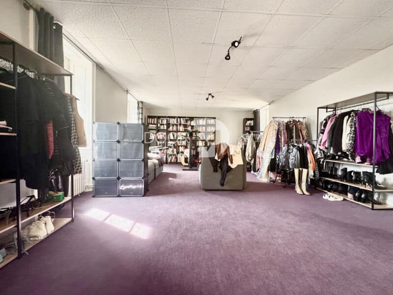 Interior of a house in Laval with clothes shelves and a spacious living area.