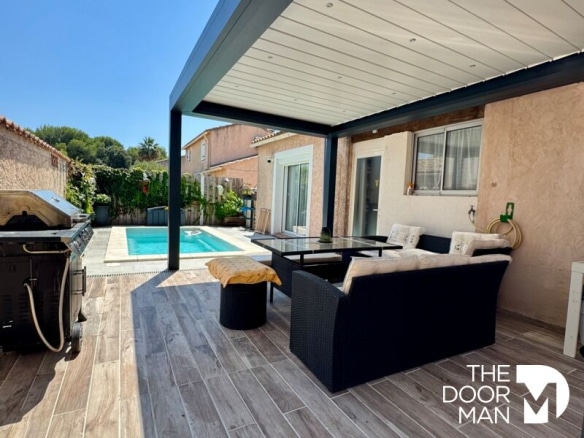 Covered terrace with lounge and swimming pool in La Londe-les-Maures.