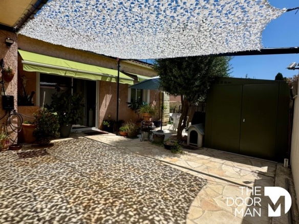 Terrace of a house with swimming pool, shaded by a sail, in La Londe-les-Maures.