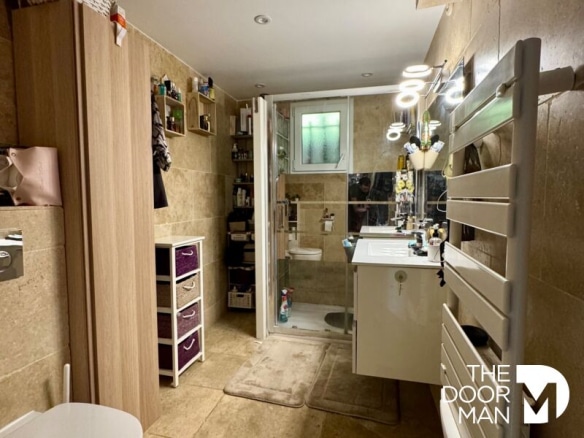 Modern bathroom with shower and vanity unit in a family home.