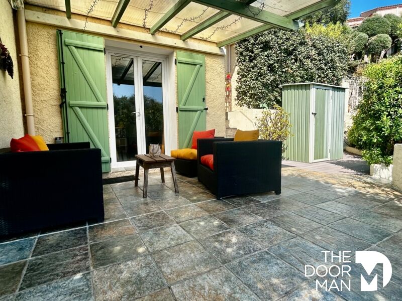 Terrace of a house in Le Lavandou Terrace of a house with outdoor furniture and unobstructed view of a garden.