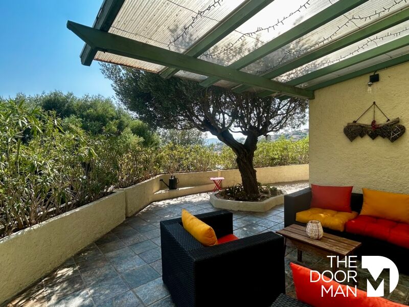 Terrace of a house in Le Lavandou Terrace of a house with sofa and unobstructed view of the vegetation in Le Lavandou.